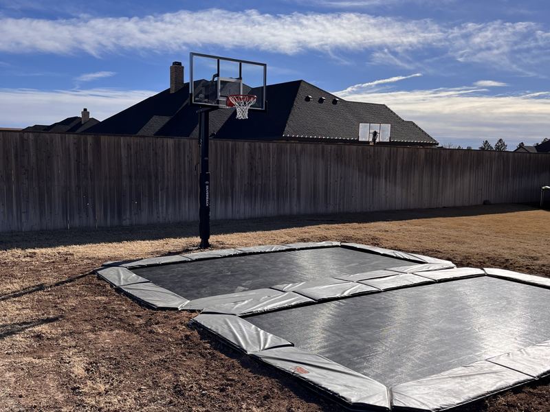 Finished in-ground trampoline install with basketball hoop