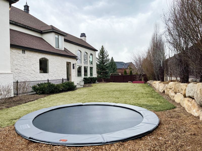 In-ground trampoline installed in a backyard